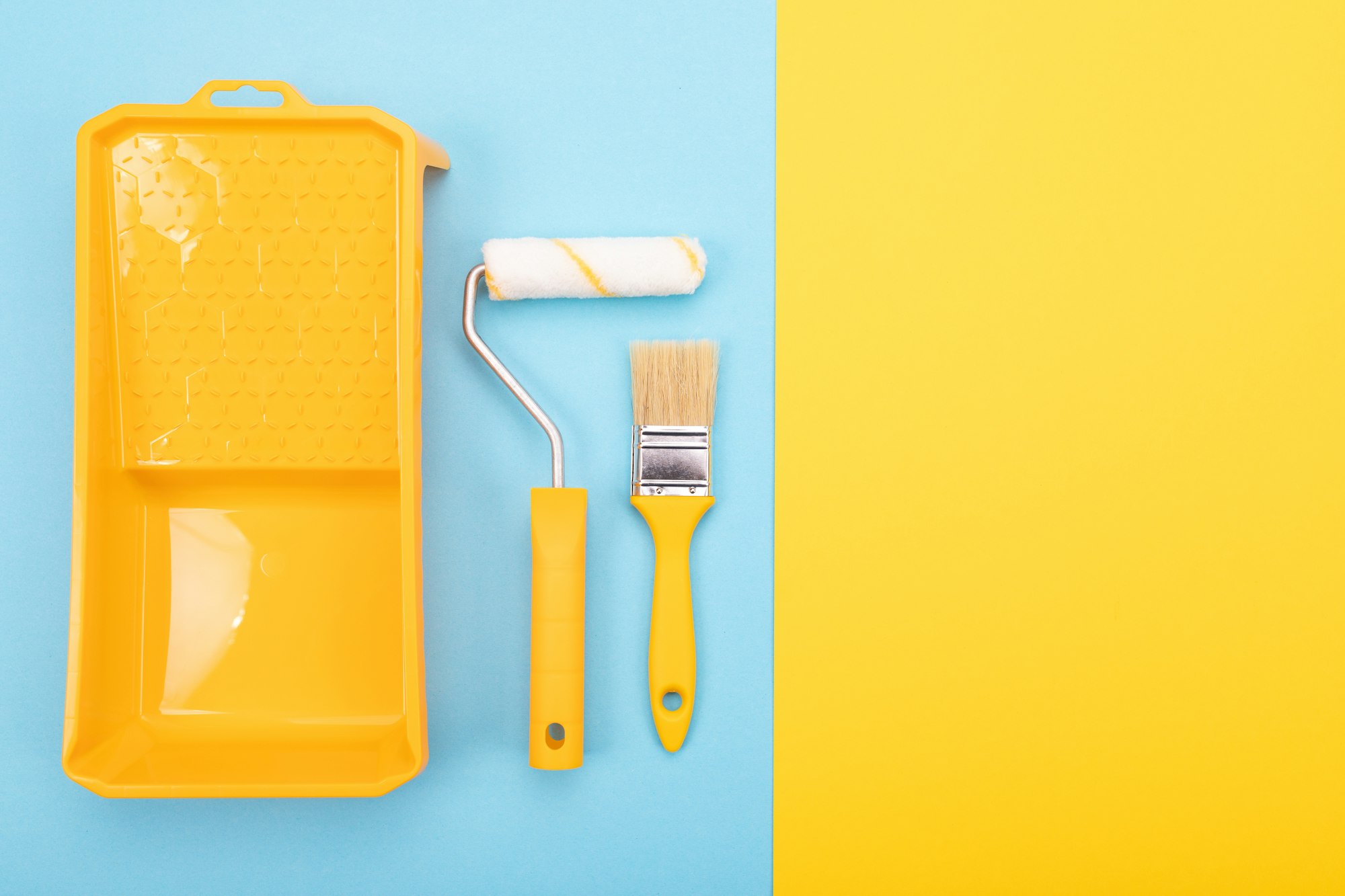 Paint tools. Paint brush and roller with tray for paint.